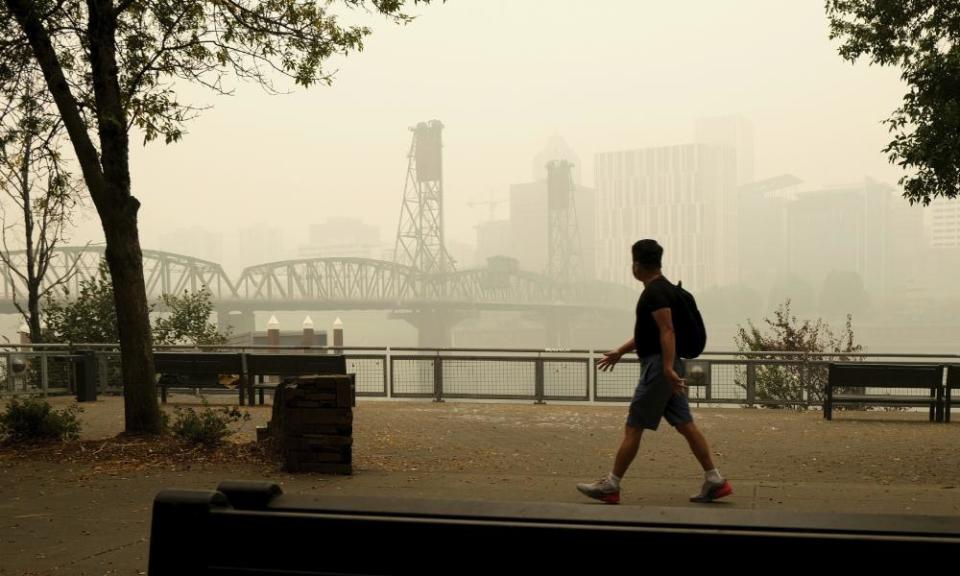 A pedestrian walks past the Willamette Bridge and downtown Portland, Oregon, on Wednesday.