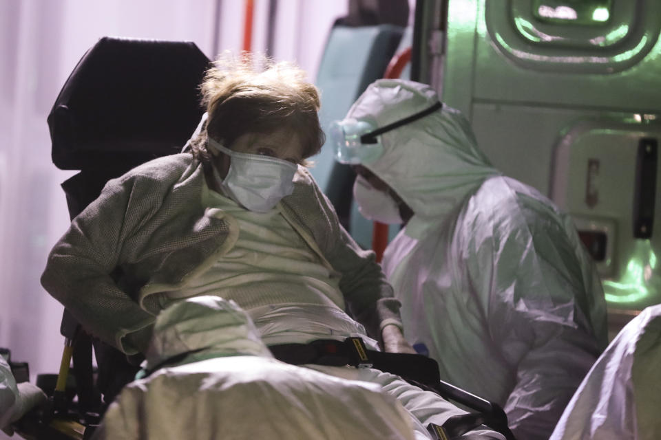 Medical staff evacuate an elderly from a nursing home after multiple residents of the facility tested positive for the coronavirus in Buenos Aires, Argentina, April 21, 2020. (AP Photo/Natacha Pisarenko)