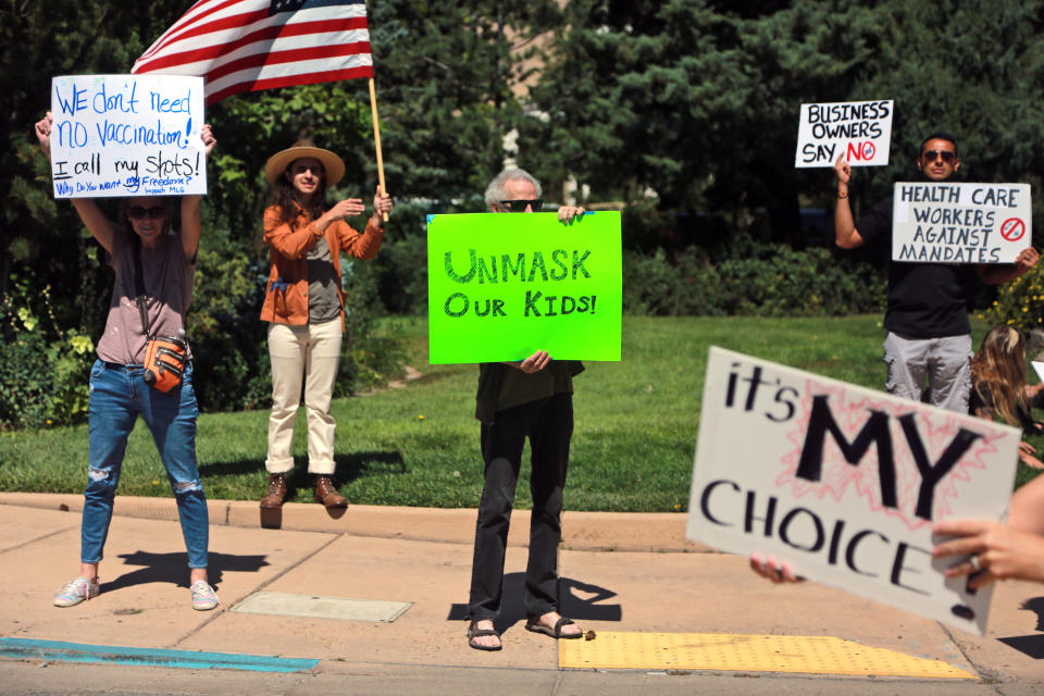 FILE - In this Aug. 20, 2021, file photo, protesters against vaccine and mask mandates demonstrate near the state capitol, in Santa Fe, New Mexico. Last spring, as false claims about vaccine safety threatened to undermine the world's response to COVID-19, researchers at Facebook wrote that they could reduce vaccine misinformation by tweaking how vaccine posts show up on users' newsfeeds, or by turning off comments entirely. Yet despite internal documents showing these changes worked, Facebook was slow to take action. (AP Photo/Cedar Attanasio, File)