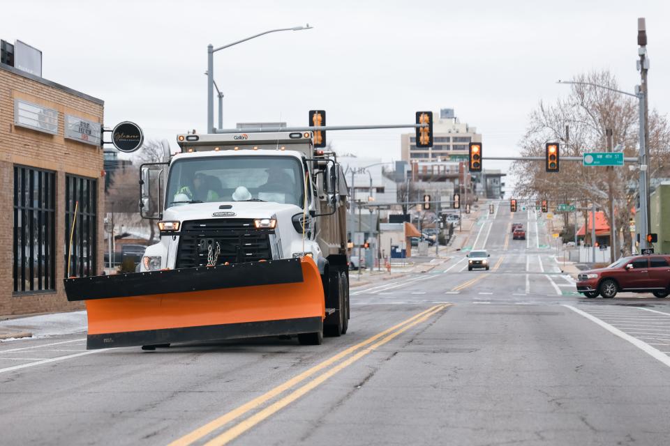 A snow plow drives in Oklahoma City on Tuesday, Jan. 9, 2024.