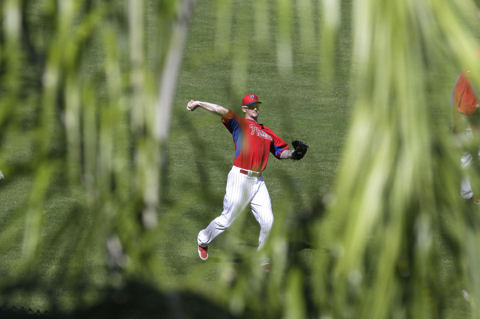 Philadelphia Phillies pitcher A.J. Burnett throws in the outfield during spring training baseball practice on Sunday, Feb. 16, 2014, in Clearwater, Fla. (AP Photo/Charlie Neibergall)