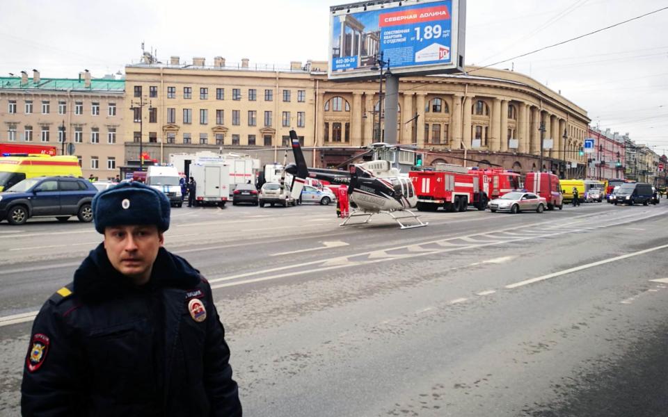 Emergency vehicles and a helicopter are seen at the entrance to - Credit: RUSLAN SHAMUKOV/AFP/Getty Images