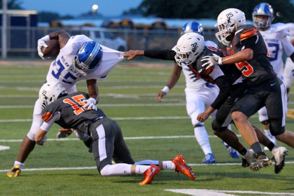 Bladen Biner of Burkburnett makes the tackle on Nolan Catholic's Emeka Megwa Friday night in Burkburnett as the Bulldogs hosted the Vikings in Friday night action.