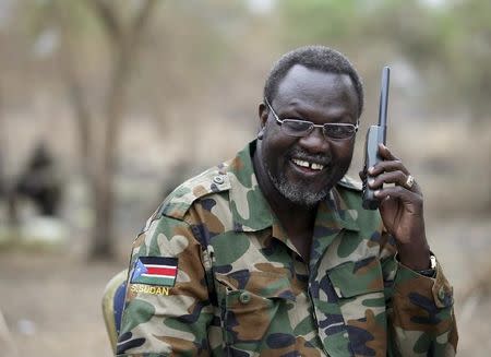 South Sudan's rebel leader Riek Machar talks on the phone in his field office in a rebel-controlled territory in Jonglei State, South Sudan, February 1, 2014. REUTERS/Goran Tomasevic/File Photo