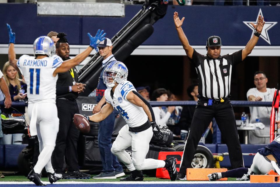 Lions wide receiver Amon-Ra St. Brown celebrates a touchdown against the Cowboys with wide receiver Kalif Raymond during the second half of the Lions' 20-19 loss at AT&T Stadium in Arlington, Texas on Saturday, Dec. 30, 2023.