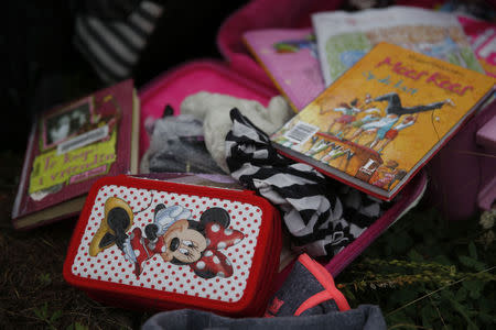 Passengers' belongings are pictured at the crash site of Malaysia Airlines flight MH17 before a visit by Organisation for Security and Cooperation in Europe (OSCE) monitors, near the settlement of Grabovo in the Donetsk region, July 18, 2014. REUTERS/Maxim Zmeyev