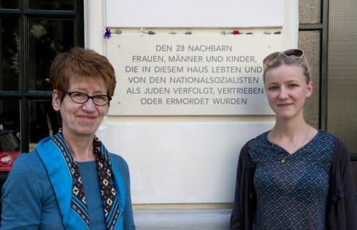 Berlin tenants Gabrielle Pfaff (left) and Lydia Zabel with a plaque commemorating Jews evicted during the Nazi era from the building in which they live. Thanks to the efforts of a group of Berliners to trace the Jewish residents who once lived in their building, the victims are finally being openly remembered