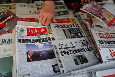 Chinese news papers showing U.S. President Donald J. Trump at a newsstand in Shanghai, China January 21, 2017. REUTERS/Aly Song