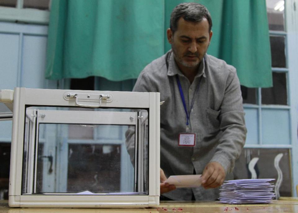 An Algerian poll worker begins counting votes in the presidential election in an Algiers polling station, Thursday April 17, 2014. Algerians headed to the polls to elect a president in a contest widely expected to be won by 77-year-old incumbent Abdelaziz Bouteflika who is running for a fourth term. (AP Photo/Paul Schemm)