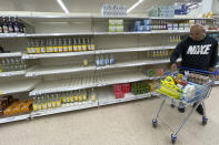 A view of empty shelves at a supermarket in London, Monday, Sept. 20, 2021. Retailers, manufacturers and food suppliers have reported disruptions due to a shortage of truck drivers linked to the pandemic and Britain's departure from the European Union, which has made it harder for many Europeans to work in the U.K. (AP Photo/Frank Augstein)