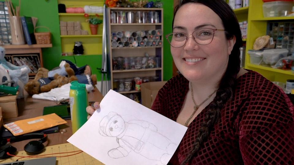 Vermont Teddy Bear designer Cassandra Clayton holding up one of her sketches at her studio in Shelburne on May 5, 2023.