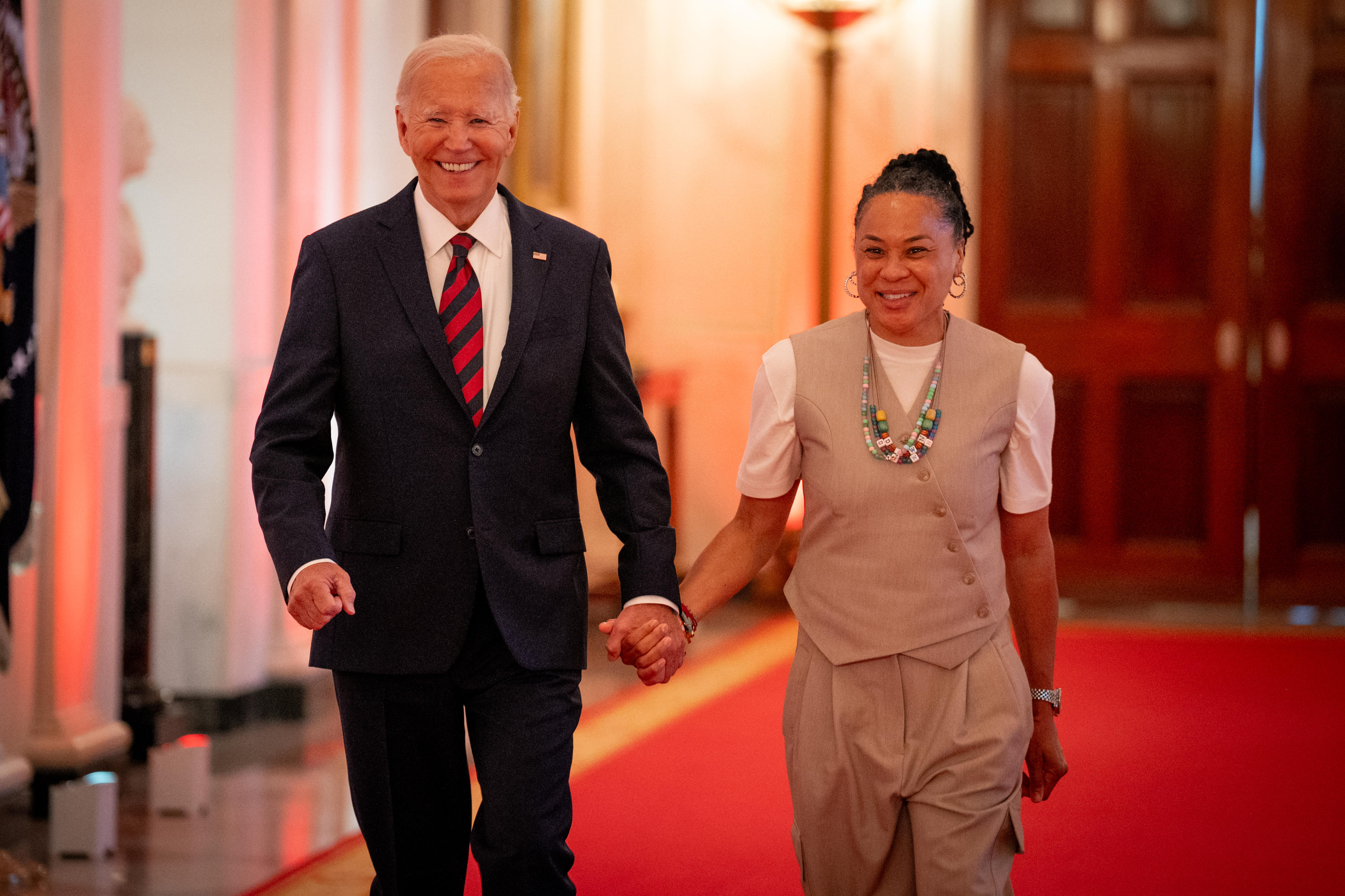 WASHINGTON, DC - SEPTEMBER 10: U.S. President Joe Biden and South Carolina Gamecocks Head Coach Dawn Staley arrive for a celebration of the 2023-2024 University of South Carolina Gamecocks Women's Basketball NCAA championship team in the East Room at the White House on September 10, 2024 in Washington, DC. The Gamecocks ended their season undefeated and beat the Iowa Hawkeyes 87-75 for their third NCAA Championship with Head Coach Dawn Staley. (Photo by Andrew Harnik/Getty Images)