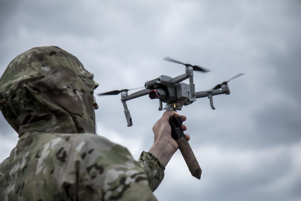 A Ukrainian serviceman attach a 3D version of an explosive as he trains to drop explosives devices from a drone in a secret location in Lviv Oblast, Ukraine.