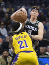 Sacramento Kings guard Kevin Huerter (9) is fouled by Los Angeles Lakers guard Patrick Beverley (21) during the first quarter of an NBA basketball game in Sacramento, Calif., Wednesday, Dec. 21, 2022. (AP Photo/José Luis Villegas)