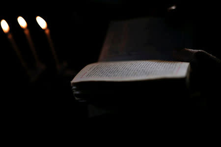 An Orthodox priest reads the gospel during the baptism of the first baby born on the islet of Thymaina after six years, with the financial support of the Aegean Team doctors, on the islet of Ayios Minas, Greece, May 12, 2017. REUTERS/Alkis Konstantinidis