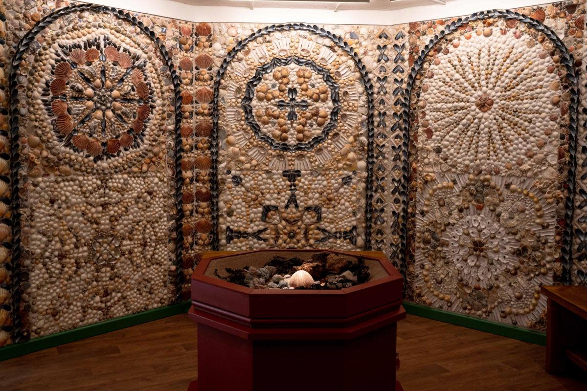 A visitor exploring the Room of Discovery at A la Ronde. <i>(Image: Sophie Bolsworth)</i>