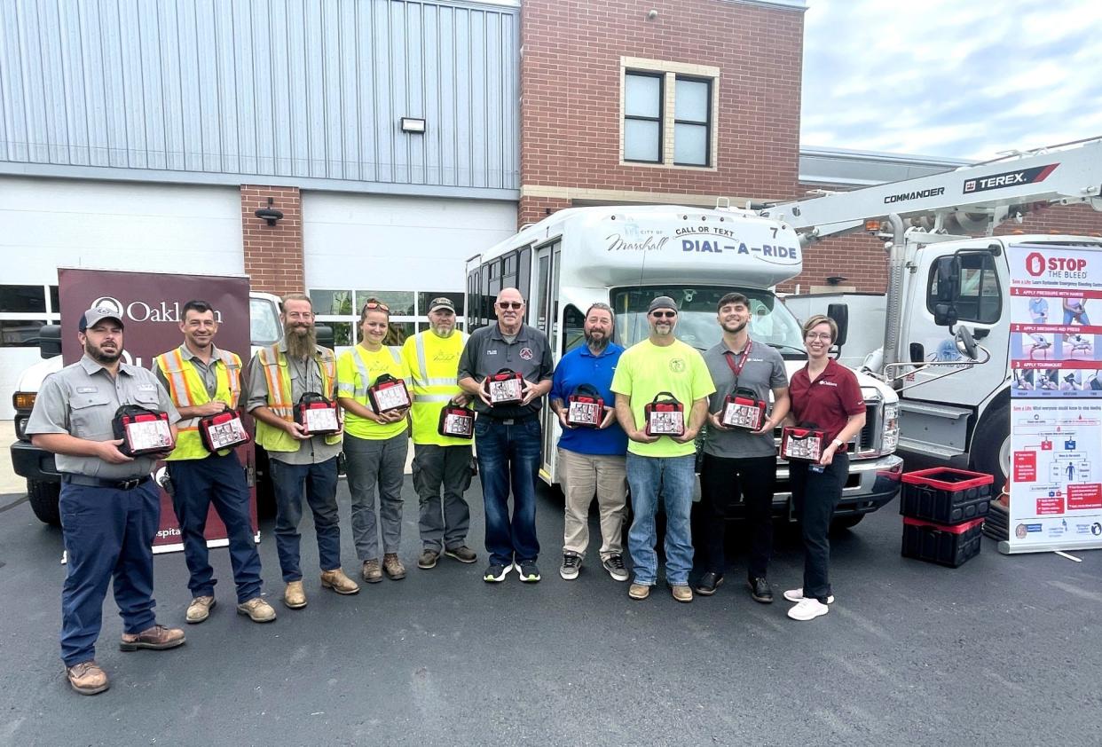 City of Marshall employees display new bleeding control kits provided by Oaklawn Medical Group. Pictured, from left, are city employees Eric Weberling (Wastewater), Reuben West (Water), Jeremiah Steele (Water), Karley Johnson (DPW) and Tim Wise (DPW), Marshall Fire Chief Martin Erskine, Matt McKee (Dial-A-Ride), Jason Erb (Electric), Aidan Belew (Oaklawn Marketing) and Oaklawn Director of Emergency Preparedness Sarah Hughes.