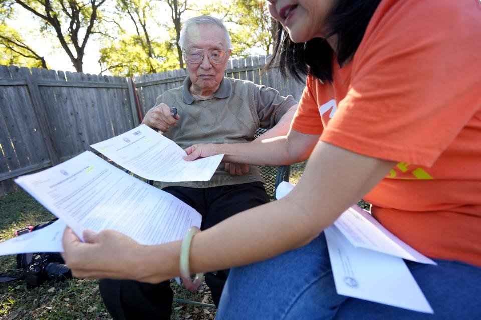Alice Yi and her 92-year-old father Yilu Zhao discuss how his mail in ballot was rejected several times because of a non-ID match in Alice’s backyard Friday, Oct. 21, 2022, in Austin. Zhao’s application was accepted too late for him to vote by mail for primary elections but was able to vote by mail for this election.