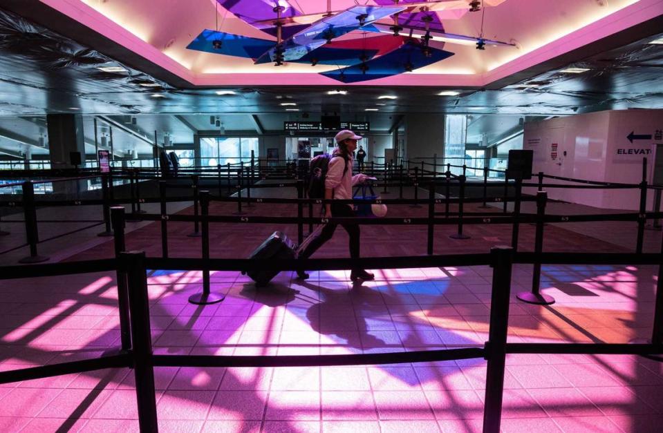 A traveler walks through security at Sacramento International Airport in 2020. The market for new hotels is booming by SMF. A dual-branded Hyatt opened last month and four more hotels are planned nearby.