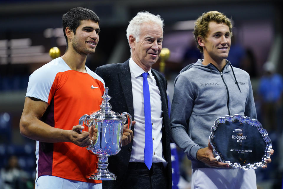 Carlos Alcaraz, of Spain, left, and Casper Ruud, of Norway, right, pose for a photo with John McEnroe after the men's singles final of the U.S. Open tennis championships, Sunday, Sept. 11, 2022, in New York. (AP Photo/Matt Rourke)