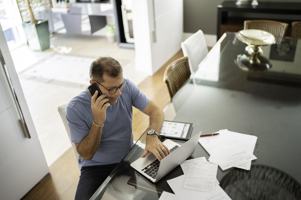 man using smartphone in home office