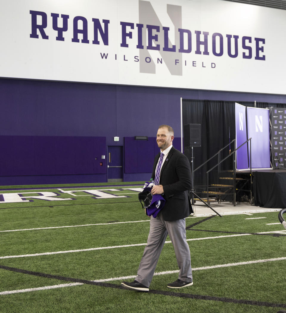 David Braun smiles after a ceremony announcing him as the official head coach of Northwestern's NCAA college football team Thursday, Nov. 16, 2023, in Evanston, Ill. Northwestern looks to become bowl eligible when it hosts Purdue in its first game since coach Braun had the interim tag removed from his job title. The school made that move on Wednesday. (Stacey Wescott/Chicago Tribune via AP)