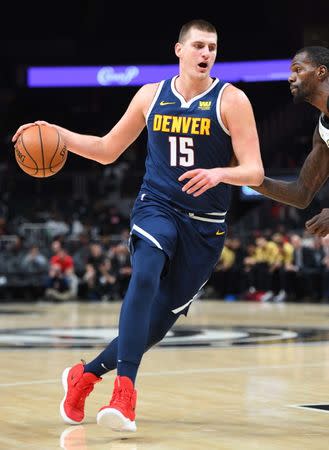 Dec 8, 2018; Atlanta, GA, USA; Denver Nuggets center Nikola Jokic (15) drives to the basket during the first half against the Atlanta Hawks at State Farm Arena. Christopher Hanewinckel-USA TODAY Sports