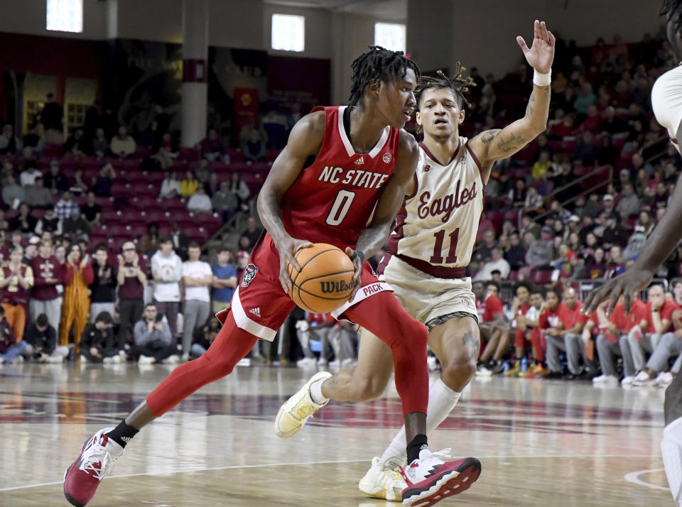 North Carolina State's Terquavion Smith (0) drives as Boston College's Makai Ashton-Langford (11) defends during the first half of an NCAA college basketball game, Saturday, Feb. 11, 2023, in Boston. (AP Photo/Mark Stockwell)