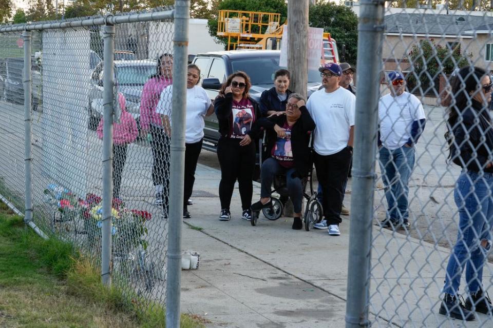 Jose's family gathers outside the recreation center on a gray Friday evening, waiting for an event that will honor him.