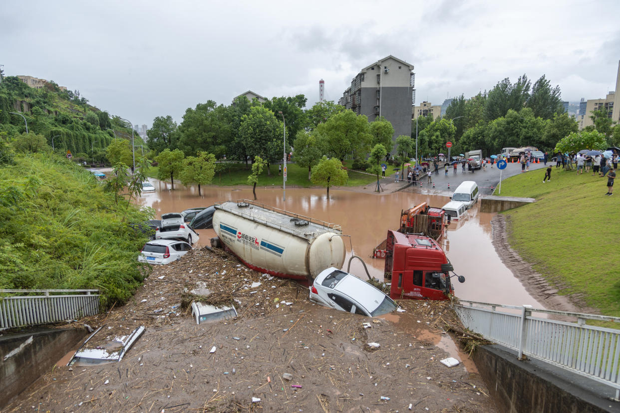 Vehicles parked on the side of a road are stuck in flood waters in Chongqing, China (Huang Wei / Xinhua News Agency via Getty Images file )
