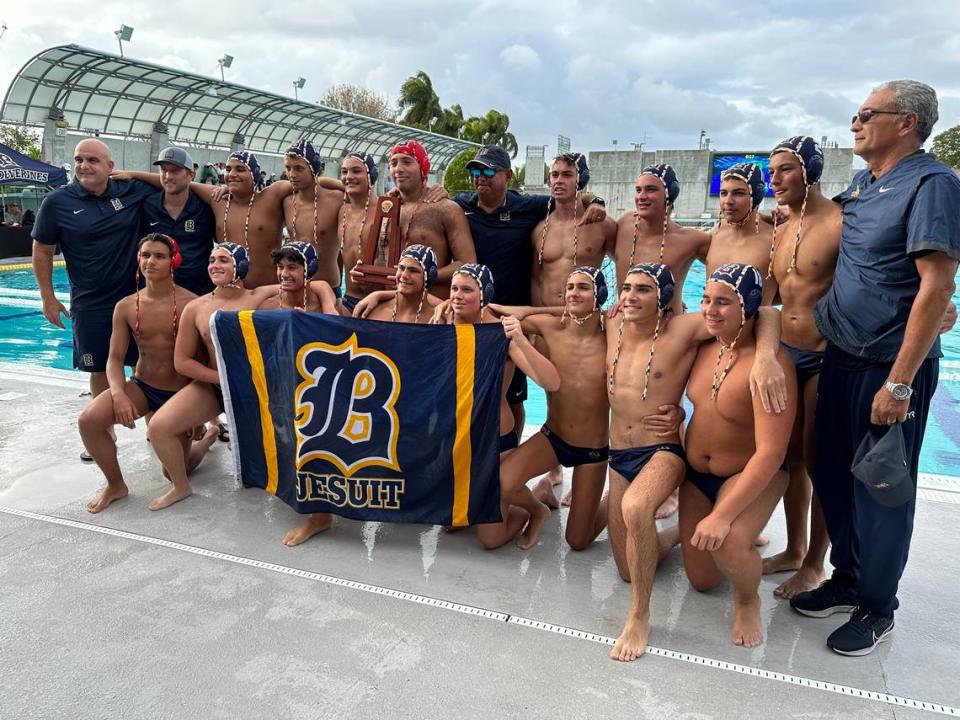 Belen Jesuit’s boys’ water polo team celebrates its regional championship on Tuesday afternoon following a 13-10 victory over Gulliver Prep.