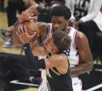 Atlanta Hawks guard Trae Young, front, draws a foul from Philadelphia 76ers center Joel Embiid on his way to the basket during Game 4 of a second-round NBA basketball playoff series on Monday, June 14, 2021, in Atlanta. (Curtis Compton/Atlanta Journal-Constitution via AP)