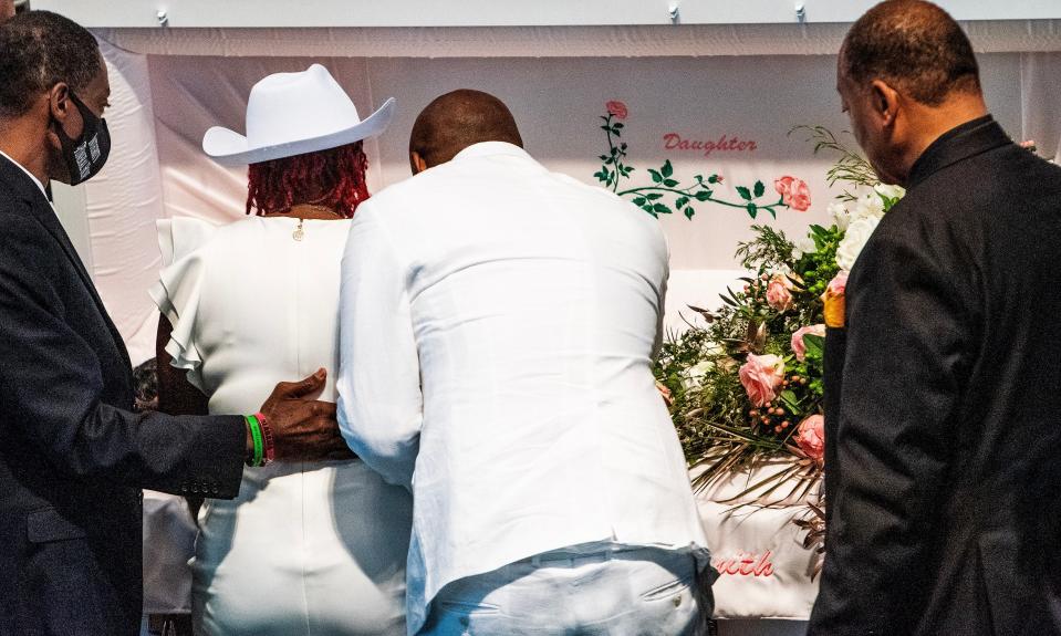 The parents of Shaunkivia ‘Keke’ Smith stand over her casket during her funeral, held at First Baptist Church in Dadeville, Ala, on Saturday April 29, 2023.  Smith was one of the four victims who died in the Dadeville shooting.