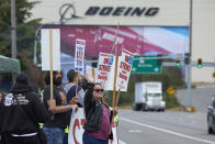 Boeing Machinists Union member Stephanie Corona waves to passing traffic while on the picket line at the Everett plant, Friday, Sept. 13, 2024, in Everett, Wash. (AP Photo/John Froschauer)