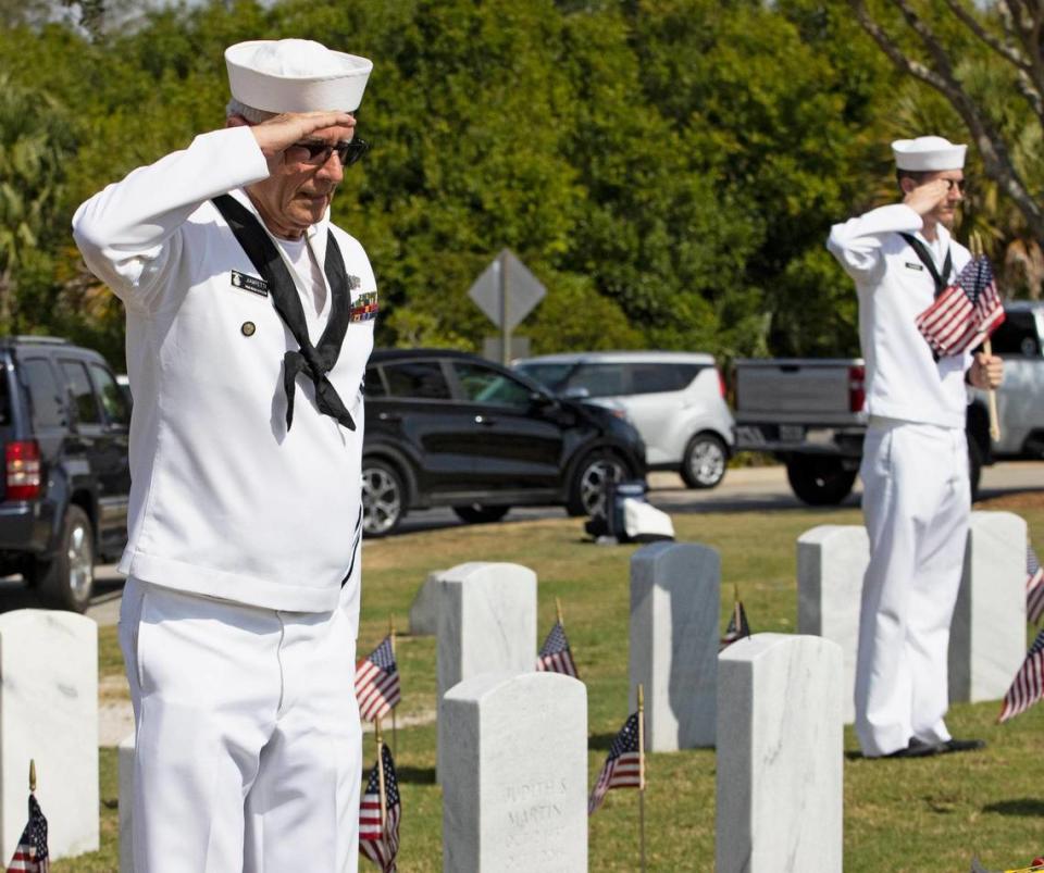 Retired Navy and U.S. Naval Sea Cadet Corps leader Joe Jiampetti alongside Cadet Carlo Fulgenzi salute veterans’ graves after placing American flags at the South Florida National Cemetery in Lake Worth in preparation for a Memorial Day ceremony on Monday.