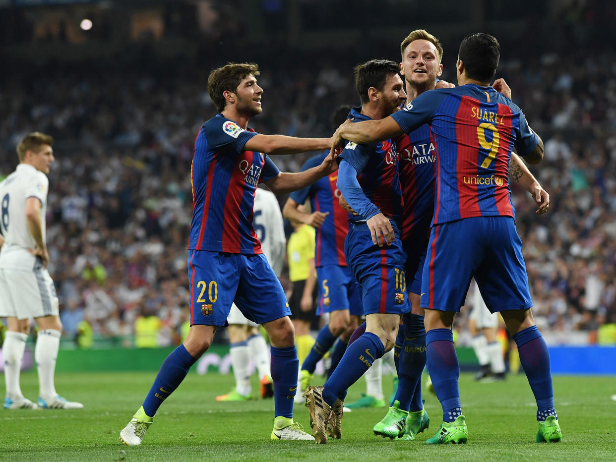 Barcelona celebrate as Lionel Messi inspired the 3-2 victory over Real Madrid: Getty