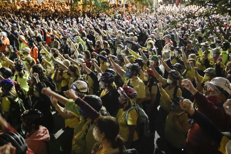 Demonstrators raise their fists during a Black Lives Matter protest at the Mark O. Hatfield United States Courthouse Thursday, July 23, 2020, in Portland, Ore. (AP Photo/Marcio Jose Sanchez)