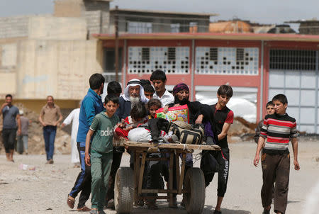 Displaced Iraqis walk as they flee after a battle between the Iraqi Counter Terrorism Service and Islamic State militants in western Mosul, Iraq, April 22, 2017. REUTERS/Muhammad Hamed