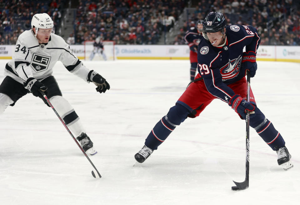 Columbus Blue Jackets forward Patrik Laine, right, controls the puck in front of Los Angeles Kings forward Arthur Kaliyev during the second period of an NHL hockey game in Columbus, Ohio, Sunday, Dec. 11, 2022. (AP Photo/Paul Vernon)