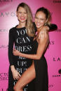 Fellow African models Behati Prinsloo and Candace Swanepoel ham it up for the camera on their way into the Victoria's Secret fashion show after party.