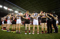 St Kilda and Essendon link arms post-game.