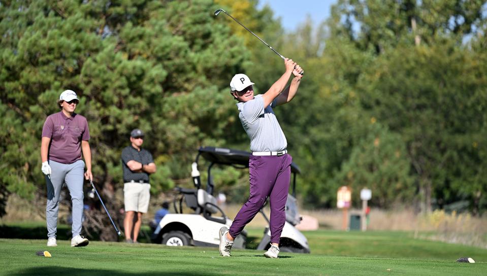 Junior Kaden Rylance of Watertown follows through with a tee shot as Harrisburg's Hayden Scott looks on during the opening round of the state Class AA high school boys golf tournament on Monday, Oct. 2, 2023 at the Brandon Golf Course.