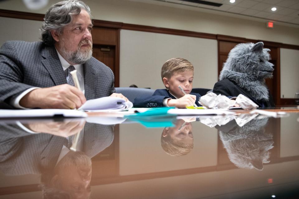 The Big Bad Wolf's defense team, Greg Turman and Alex Chappell, of East Cliff Elementary, take notes during a mock trial at the Federal Courthouse on Thursday, Nov. 16, 2023, in Corpus Christi, Texas. Drake McElyea, portraying the wolf, listens to closing arguments.