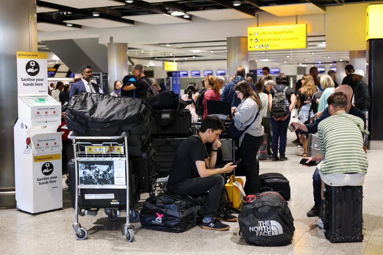 Travellers wait near the British Airways check-in area at Heathrow Airport, as Britain’s National Air Traffic Service (Nats) restricts UK air traffic due to a technical issue causing delays, in London, Britain, 28 August 2023 (Reuters)