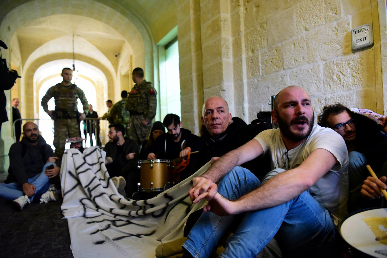 Activists sit after having barged into the building of Malta's Prime Minister Joseph Muscat's office, demanding his resignation in the wake of developments in case of the 2017 murder of anti-corruption journalist Daphne Caruana Galizia, in Valletta, Malta, December 9, 2019. REUTERS/Mark Zammit Cordina