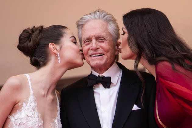 Michael Douglas — pictured with his daughter, Carys Zeta Douglas (left), and wife, Catherine Zeta-Jones, in 2023 — is still getting used to having intimacy coordinators on film sets.