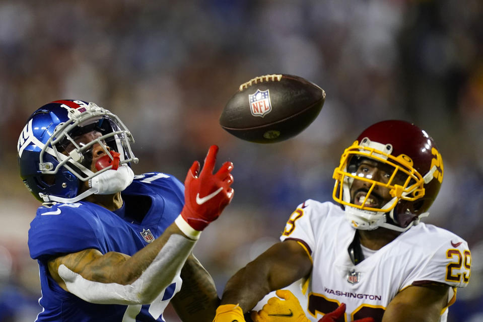 New York Giants wide receiver Kenny Golladay (19) looses control of the ball while being covered by Washington Football Team cornerback Kendall Fuller (29) during the second half of an NFL football game, Thursday, Sept. 16, 2021, in Landover, Md. (AP Photo/Patrick Semansky)