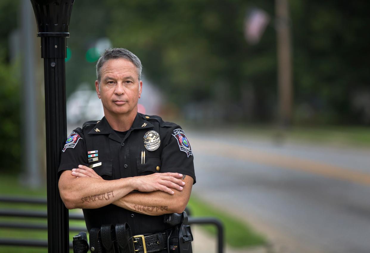 Police Chief Tom Synan leans on a post outside the Newtown Police Department.