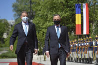 Polish President Andrzej Duda, right, reviews the honor guard with Romanian President Klaus Iohannis during the welcoming ceremony at the Cotroceni presidential palace in Bucharest, Romania, Monday, May 10, 2021. (AP Photo/Alexandru Dobre)