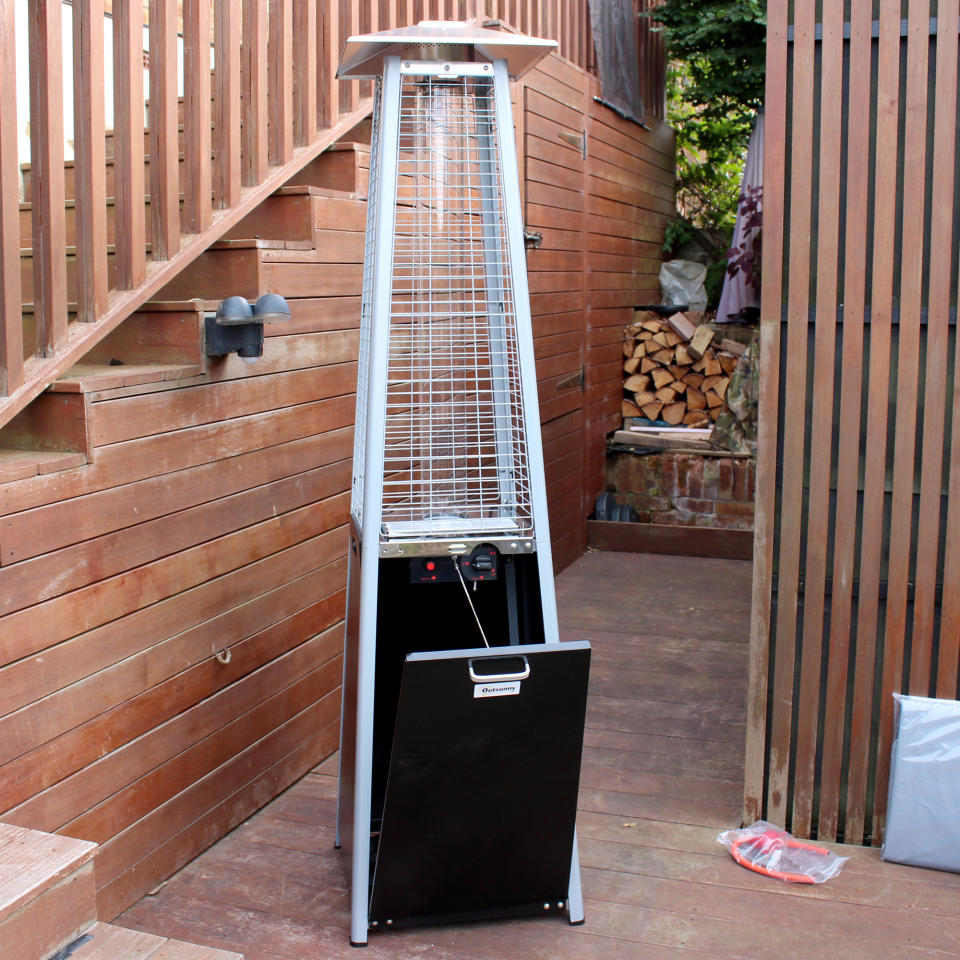 The Outsunny 11.2kw Pyramid Gas Patio Heater being unboxed and tested on a wooden deck